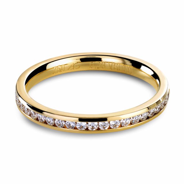 Channel set wedding band with white diamonds in yellow gold